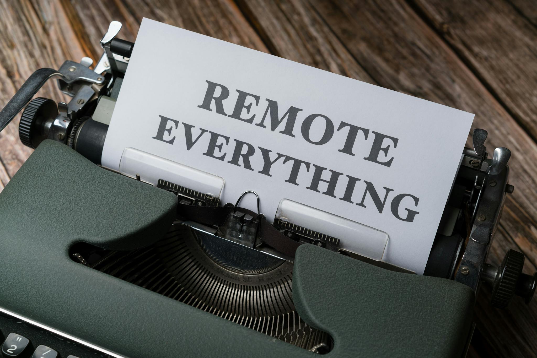 Old-fashioned typewriter with a paper showing the words 'Remote Everything', symbolizing remote work and virtual connectivity.